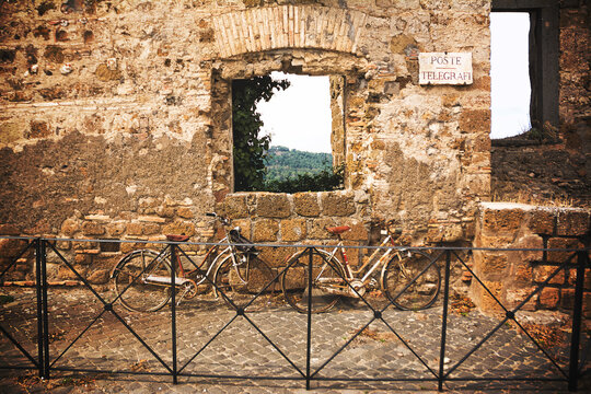 Old bicycles leaning on the old wall with the inscription "Poste e Telegrafi" (Mail e Telegraph)
