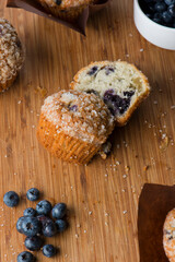 Obraz na płótnie Canvas Blueberry muffins homemade with farm fresh organic blueberries. Traditional classic American bakery or pastry shop favorite. Muffins topped with sugar. Copy Space.