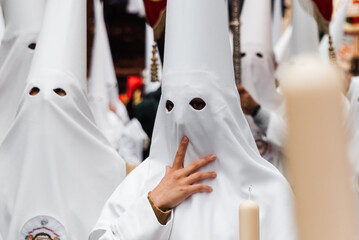 penitents in a white-dressed Easter procession in Almeria, southern Spain.