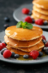 American pancakes with fresh blueberry, raspberry and honey. Healthy morning breakfast