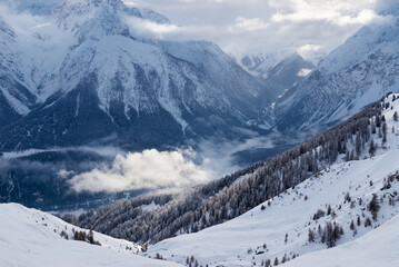 Winter view of the mountain valley near Scuol ski resort in Switzerland.