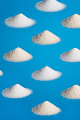 sugar and sweetener pile pattern on a blue background