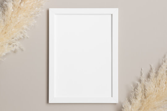 Top view of a white frame mockup with pampas decoration.