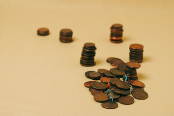 economy and work: miniature workers on coins with a yellow background