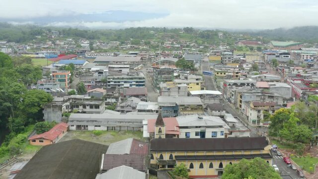 Aerial view moving over the rooftops of a small city in South America