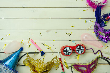 Table top view aerial image of beautiful colorful carnival festival background.Flat lay accessory object the several mask  decor confetti on modern white wooden at home office desk studio.copy space.