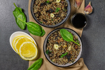 Two bowls with quinoa, mushrooms, garlic and spinach