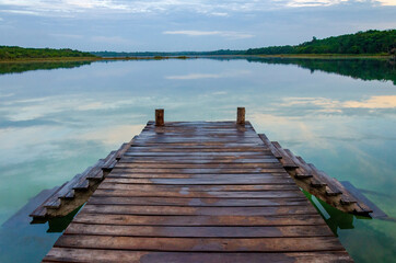 wooden pier on tropical lake - punta laguna, coba, yucatan, mexico