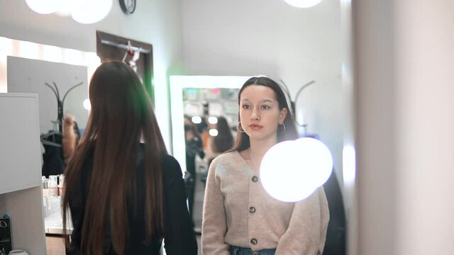 An eyebrow master takes pictures of a young girl after applying lather to her eyebrows.Eyebrow correction