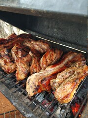 Smoky barbecue on the grill outside. The meaty taste of spring