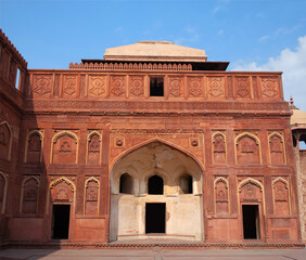 Fototapeta na wymiar Exterior of Jahangiri mahal in Agra Fort with carved details in red sandstone. Agra, Uttar Pradesh, India