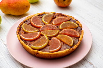 Pumpkin pie on a white wooden background.