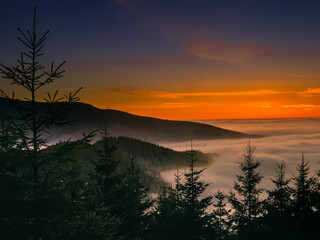 View from mountain range to the valley above fog and clouds at sunset, high altitude...