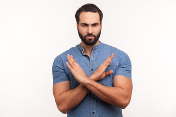 There is no way. Strict bossy bearded man in blue shirt showing x gesture with hands, rejection...
