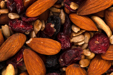 Macro of trail mix with almonds, sunflower seeds, cranberry and raisins , background and texture.