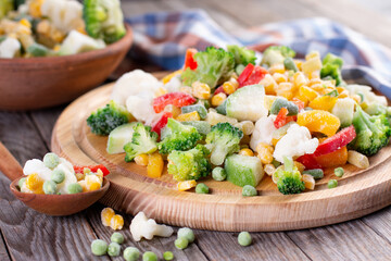 Frozen vegetables on wooden board