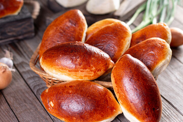 Russian pastries (pirogi) filled with eggs and green onion, closeup