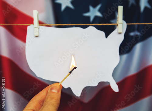 map of america USA burning match - as a symbol of  incitement to crisis and chaos of division in country.