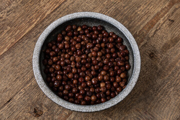 Grey peas in round  bowl on wooden table. Traditional Latvian food, Legumes bean seed - obrazy, fototapety, plakaty