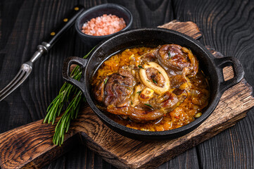 Stew veal shank meat OssoBuco,  italian osso buco steak. Black wooden background. Top view - obrazy, fototapety, plakaty