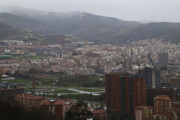 Fototapeta na wymiar View of Bilbao from a hill in a rainy day