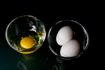 egg yolk in a glass container on a dark background