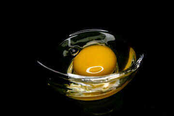 egg yolk in a glass container on a dark background