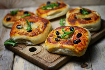 Soft focus. Homemade mini pizzas on a wooden board. Healthy food.