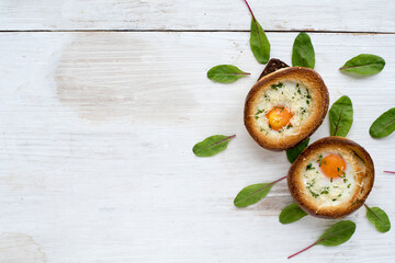 Delicious Breakfast with two baked hot rolls with eggs. View from above