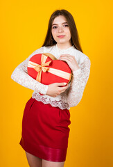 kid with gift. shopping on holidays. time for presents. happy birthday. child with box. best present ever. be my valentine. happy valentines day. teen girl hold heart shape box. love and romance