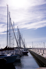 Fototapeta na wymiar Masts of many sailing boats and yachts