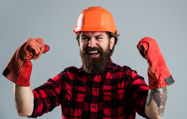 celebrating success. man in gloves. construction worker in hard hat. engineer architect working in safety helmet. brutal technician builder. factory worker mechanic. industrial worker in helmet