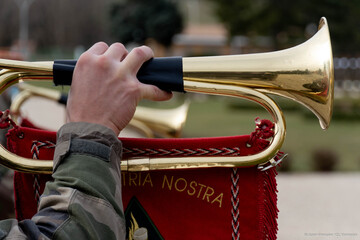 The military man plays the trumpet