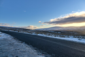 Beautiful diagonal winter view of Old Military Road (R115) traversing along the ridge of Wicklow Mountains, Co. Wicklow, Ireland. Leading lines. Irish winter