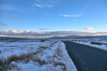 Stunning winter view of Old Military Road (R115) traversing along the ridge of Wicklow Mountains, Co. Wicklow, Ireland. Leading lines. Irish winter