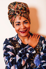 Fototapeta premium beauty bright african woman with creative make up, shawl on head like cubian closeup smiling