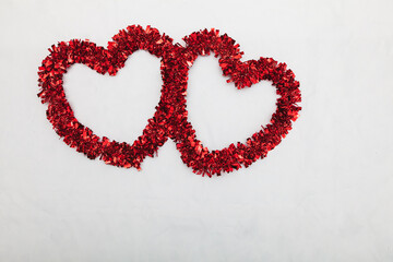 Two red hearts on a white background
