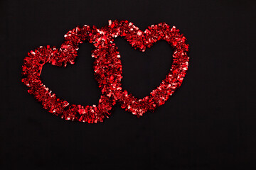 Two red hearts on a black background