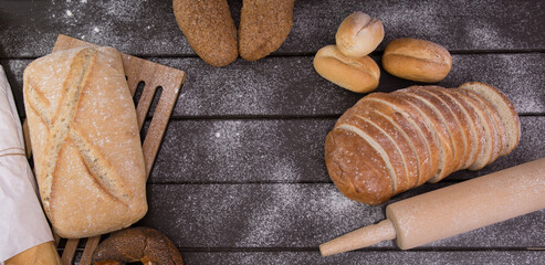 Homemade crusty bread cooking on blackboard background. Top view with space for your text