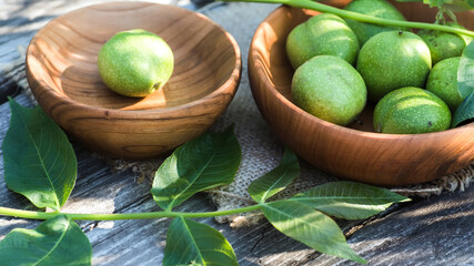 ingredients for tincture of green walnuts in a wooden ecological plate without chemicals. zero waste. Still life of nuts, wooden utensils.