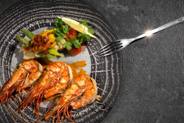 Top view of plate with shrimp and salad and fork