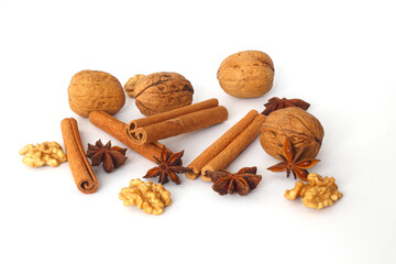spices as cinnamon stick, anise star and walnut isolated on white background