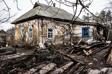 A very old house. Abandoned house, old courtyard. Vintage. Windows of an old house. Old yard with chickens. Background.