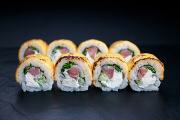 Tuna cheese grilled sushi rolls, food background