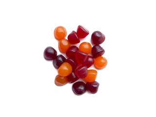 Group of red, orange and purple multivitamin gummies isolated on white background. Healthy...