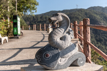 Stone statue of the Year of the Snake in GuangDong GuanYin mountain national forestpark of china.Sculpture of the Chinese Zodiac.
