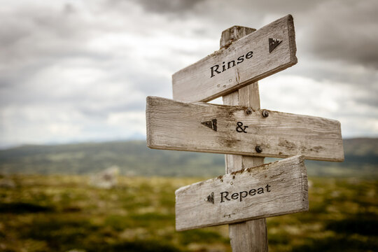 rinse and repeat signpost outdoors in nature