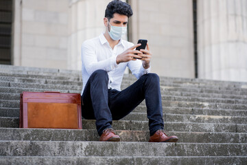 Business man using her mobile phone outdoors.