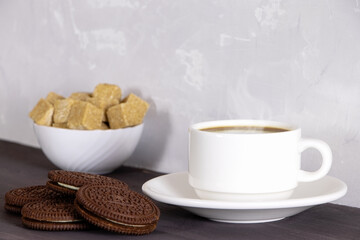 A cup of coffee and chocolate chip cookies. Breakfast with sweets and hot coffee