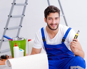 Repairman doing renovation repair in the house with paper wallpa